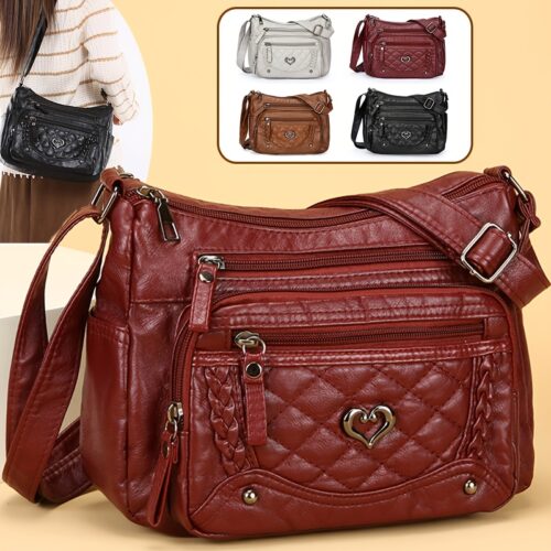 Sac à bandoulière tendance pour femme Un modèle uni et polyvalent, rehaussé d'un charmant détail en forme de cœur. Doté de multiples poches pratiques et d'une bandoulière facilement ajustable.