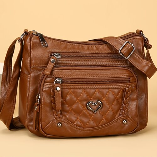 Sac à bandoulière tendance pour femme Un modèle uni et polyvalent, rehaussé d'un charmant détail en forme de cœur. Doté de multiples poches pratiques et d'une bandoulière facilement ajustable.